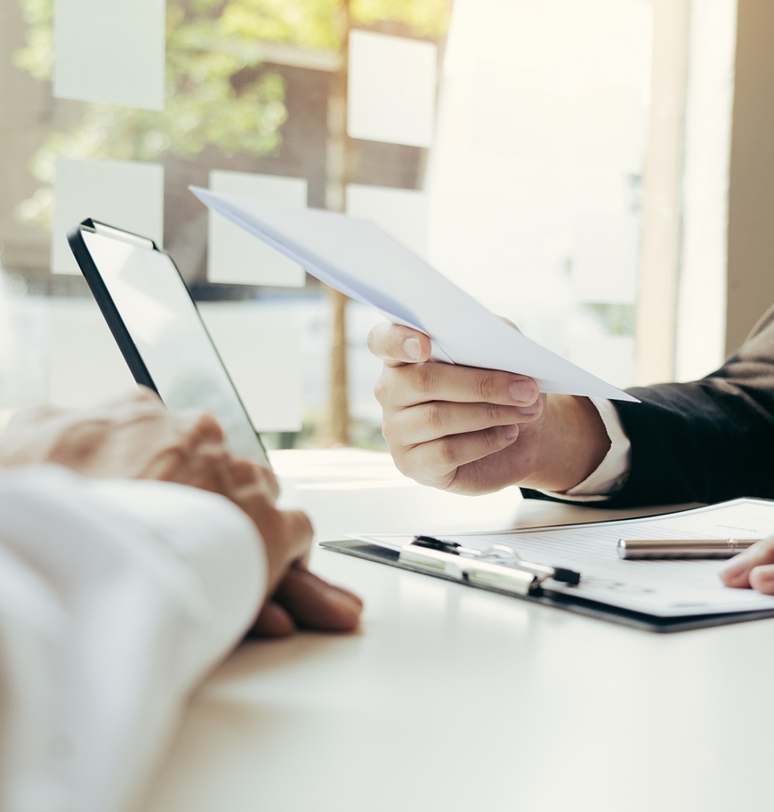 People discussing paperwork at desk
