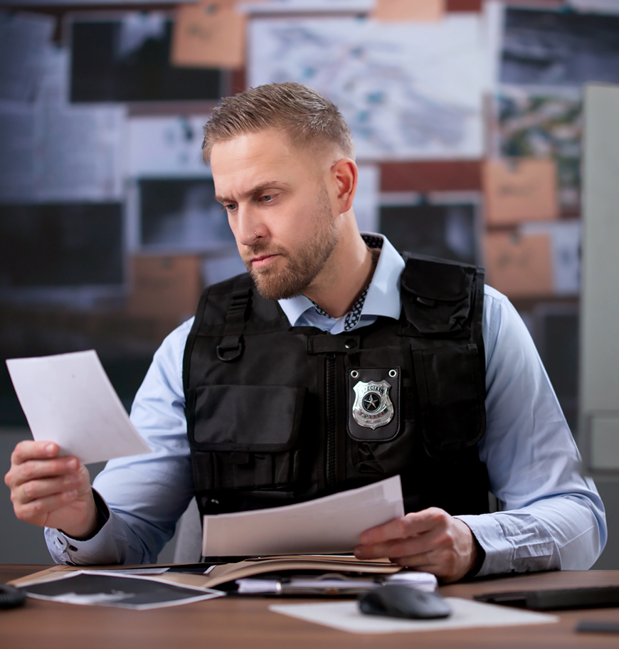 Investigator reviewing documents in office